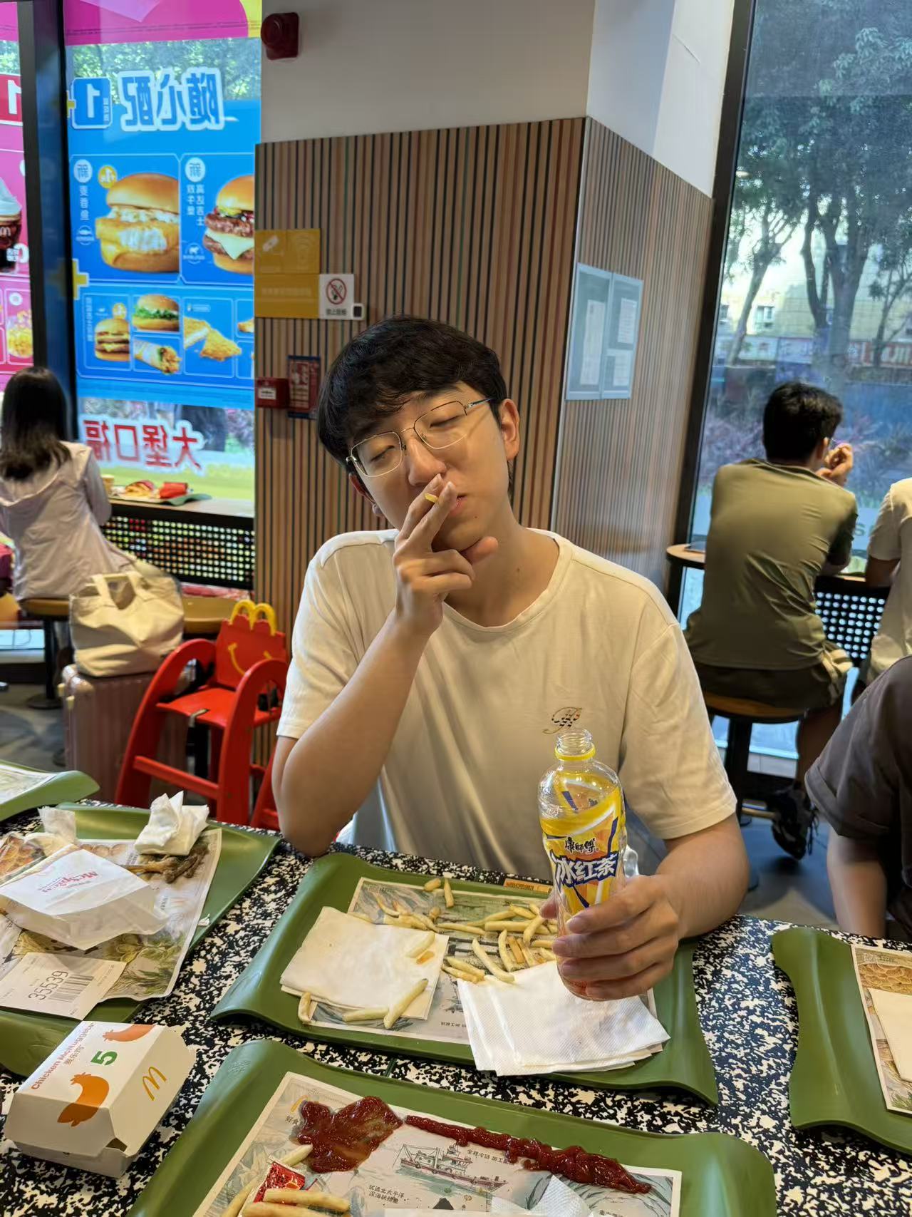 Candid photo of Hypit founder Alvin eating fries at a McDonald’s
